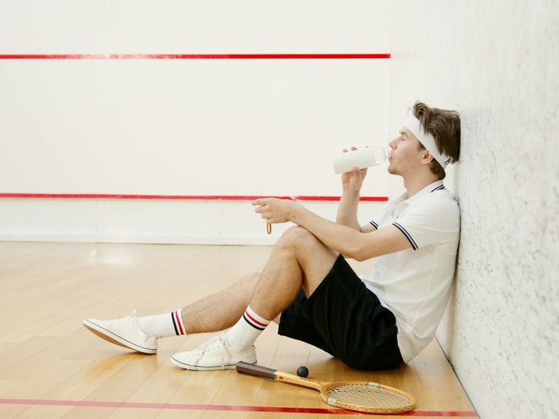 Man focused on a floor exercise, side view.